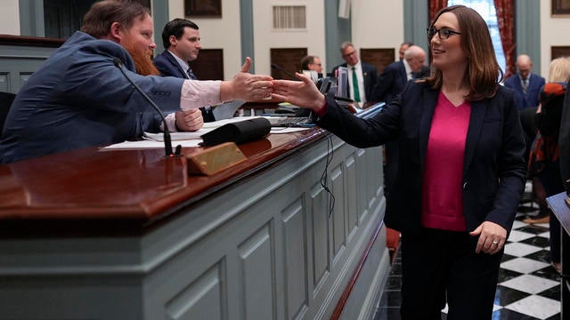 Sarah McBride gives Assistant Secretary of the Senate Daniel Yngstrom a high five on the Delaware Senate floor 