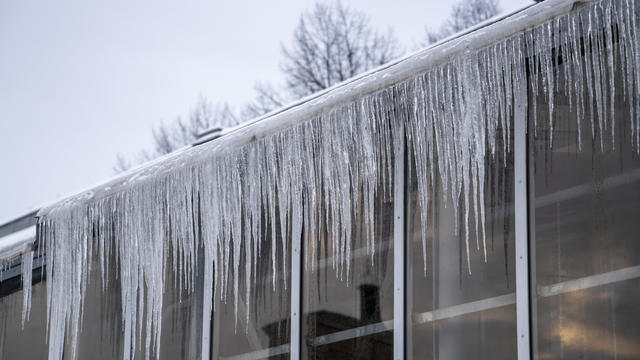 big icicles hanging outside glass walls 