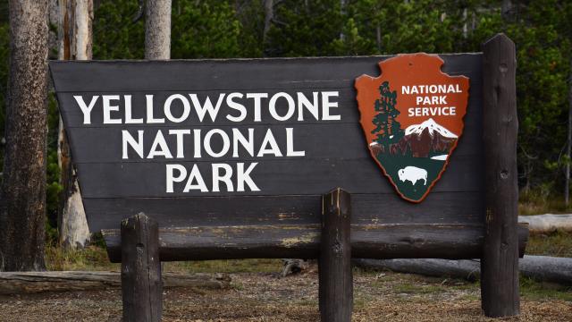 A National Park Service sign welcomes visitors to Yellowstone National Park in Wyoming, Sept. 24, 2014. 