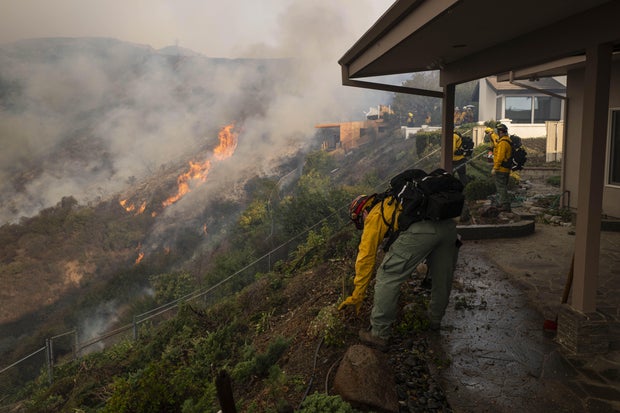 Firefighters at a home in Los Angeles