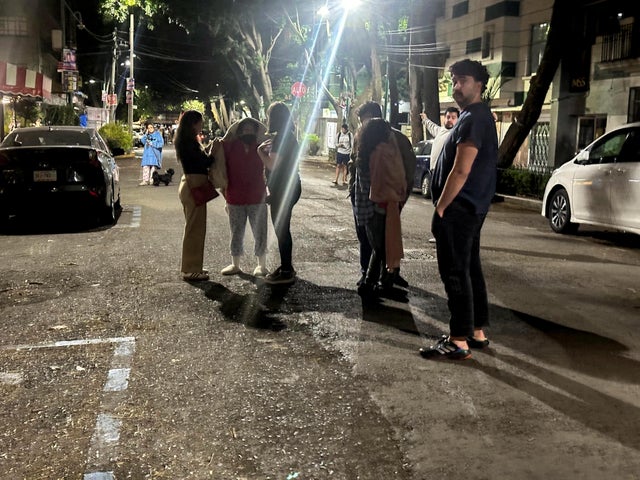 People wait outside their homes and buildings in Mexico City 
