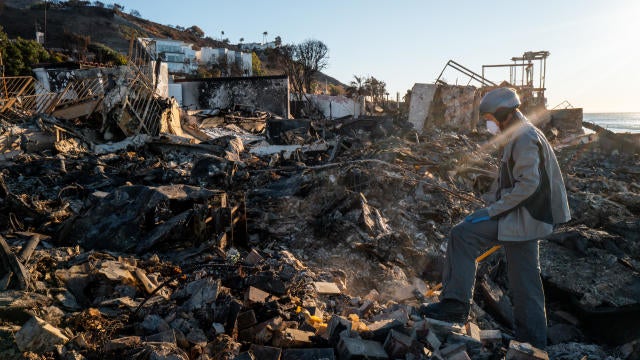 Patrick O'Neal sifts through his home after it was destroyed by the Palisades Fire on Jan. 13, 2025, in Malibu, California. 