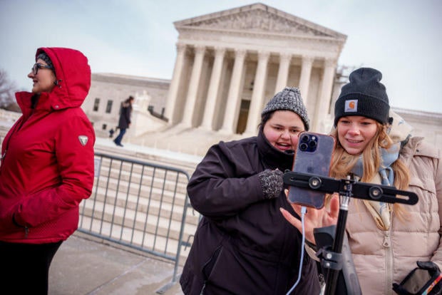 Content creators Callie Goodwin and Sarah Baus of Charleston speak to a live stream audience outside the Supreme Court on Jan. 10, 2025. 