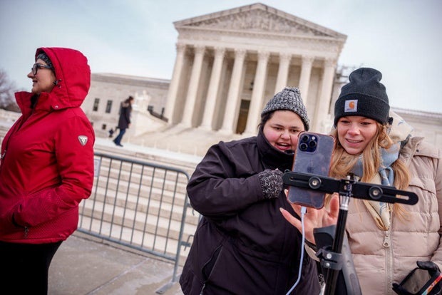 Content creators Callie Goodwin and Sarah Baus of Charleston speak to a live stream audience outside the Supreme Court on Jan. 10, 2025.