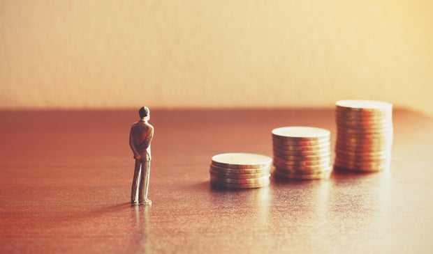 Miniature people looking future with stack coin about financial and money savings concept.