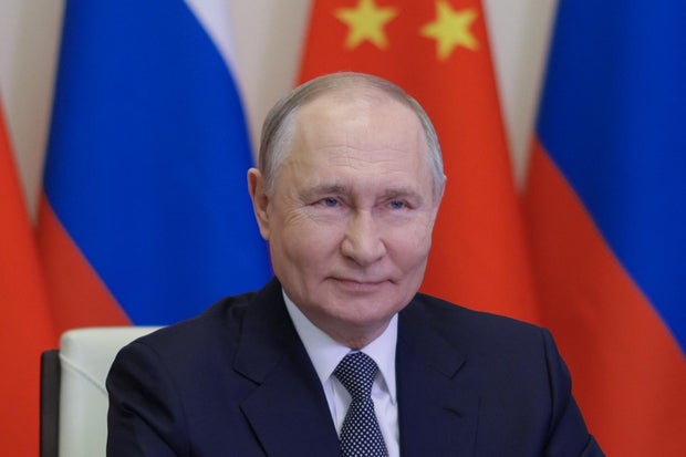 In this pool photograph distributed by the Russian state agency Sputnik, Russia's President Vladimir Putin holds a videocall with Chinese President Xi Jinping at the Novo-Ogaryovo state residence outside Moscow on Jan. 21, 2025.