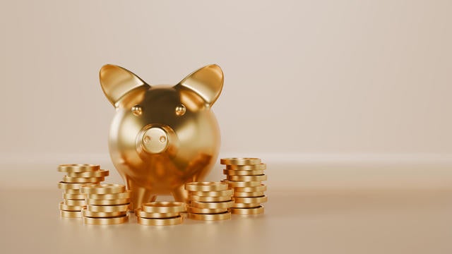 Golden piggy with coins stacking for saving and profit investment concept 