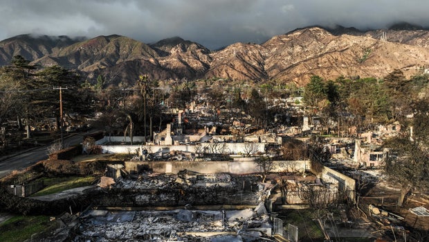 Eaton fire damaged homes and businesses in the rain. 