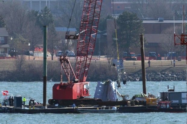 A crane pulls up a portion of an American Airlines regional plane during recovery efforts Feb. 4, 2025, in Arlington, Virginia. 