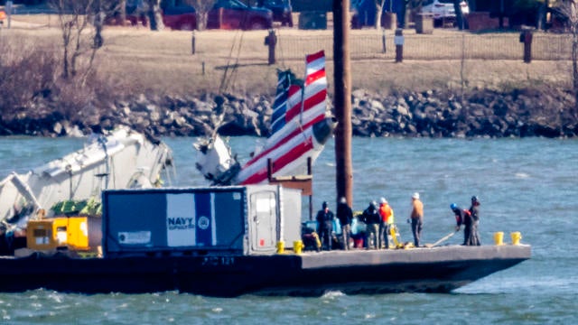 Parts of a plane are lifted from the Potomac River near the wreckage site of the midair collision between an American Airlines jet and a Black Hawk helicopter, at Ronald Reagan Washington National Airport, Feb. 4, 2025, in Arlington, Virginia. 