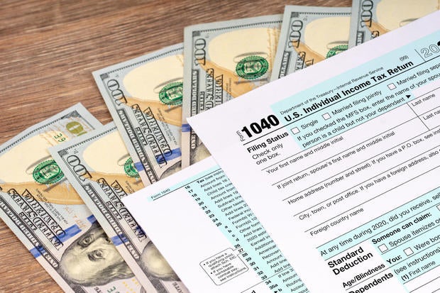 tax return application form with dollar banknotes 