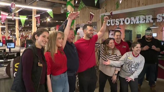 The winners of a Taylor Swift and Travis Kelce lookalike contest pose with Stew Leonard's employees. 