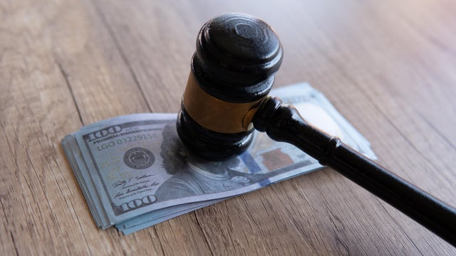 Closeup image of gavel and money. 