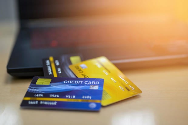 Credit cards and computers laptop placed on the desk 