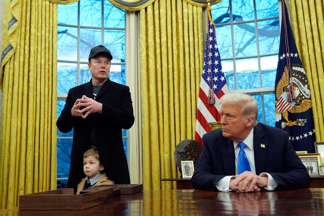 President Trump listens as Elon Musk, joined by his son, speaks in the Oval Office of the White House in Washington, D.C., on Tuesday, Feb. 11, 2025. 