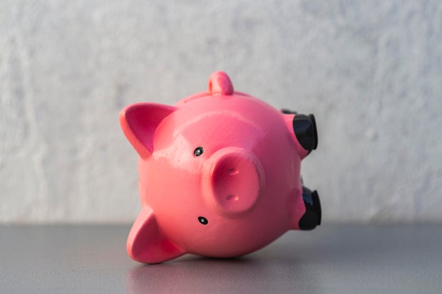 close up view of pink piggy bank upside down - finance crisis concept