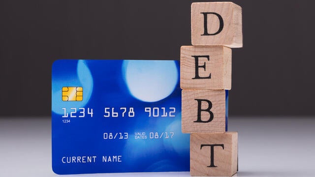 Debt Card And Debt Word On Wooden Block 