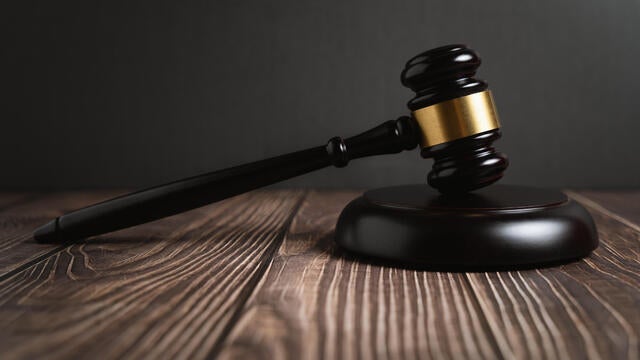 Judge's Gavel On Wooden Table 