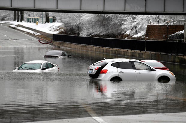 Cars sit in floodwaters at a railroad underpass in Louisville, Kentucky, Sunday, Feb. 16, 2025. 