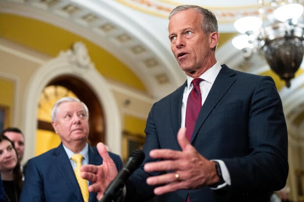 Senate Majority Leader John Thune speaks as Senate Budget Committee chairman Sen. Lindsey Graham listens during the Senate Republicans' news conference in the Capitol on Tuesday, Feb. 11, 2025.