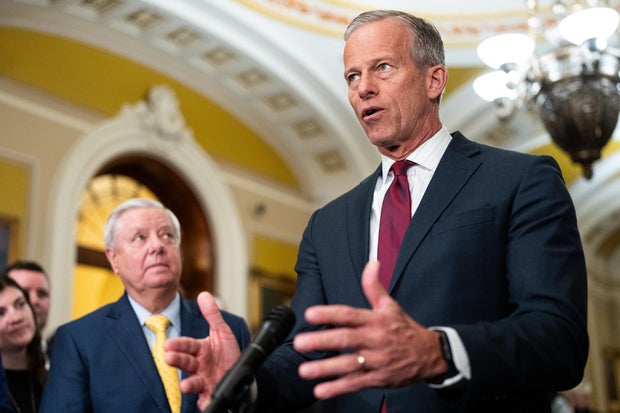 Senate Majority Leader John Thune speaks as Senate Budget Committee chairman Sen. Lindsey Graham listens during the Senate Republicans' news conference in the Capitol on Tuesday, Feb. 11, 2025.