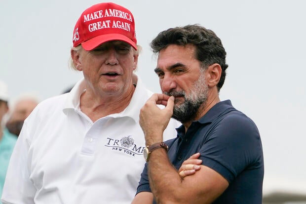 Donald Trump talks with Yasir Al-Rumayyan, governor of Saudi Arabia's Public Investment Fund, on the 16th hole during the first round of the Bedminster Invitational LIV Golf tournament on July 29, 2022.