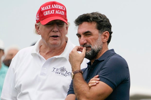 Donald Trump talks with Yasir Al-Rumayyan, governor of Saudi Arabia's Public Investment Fund, on the 16th hole during the first round of the Bedminster Invitational LIV Golf tournament on July 29, 2022.