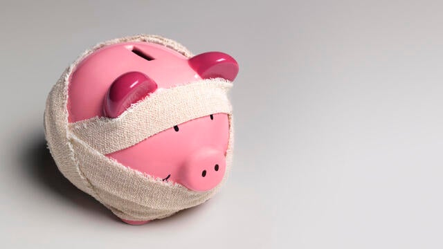 Ill piggy bank with bandages 