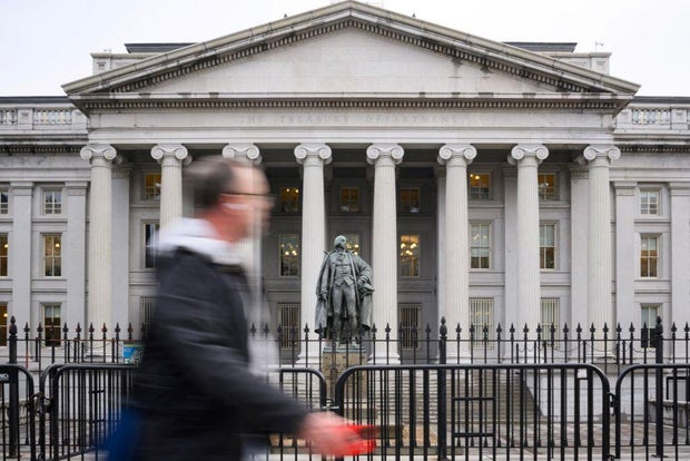 A man walks past the U.S. Treasury building in Washington, D.C., on Feb. 6, 2025.