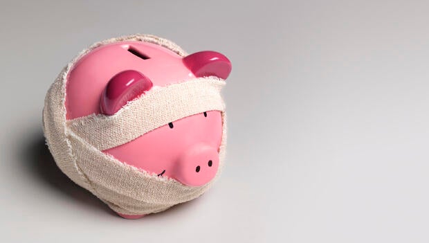 Ill piggy bank with bandages 