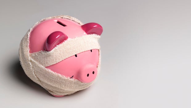 Ill piggy bank with bandages