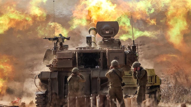 An Israeli army M109 155mm self-propelled howitzer fires rounds near the border with Gaza in southern Israel on Oct. 11, 2023.