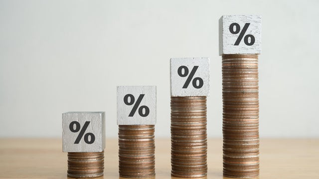 Percentage sign on increase stack coins as growth chart. 