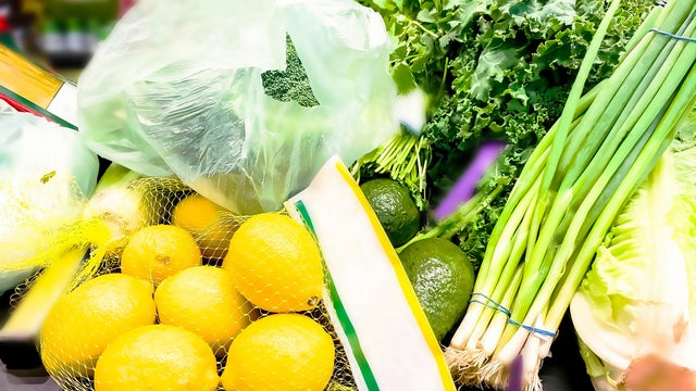 groceries on cashier's counter at market checkout