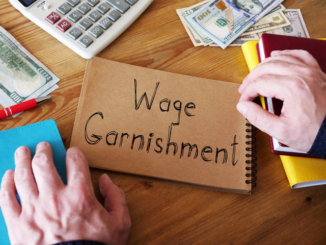 Wage Garnishment is shown on the conceptual business photo