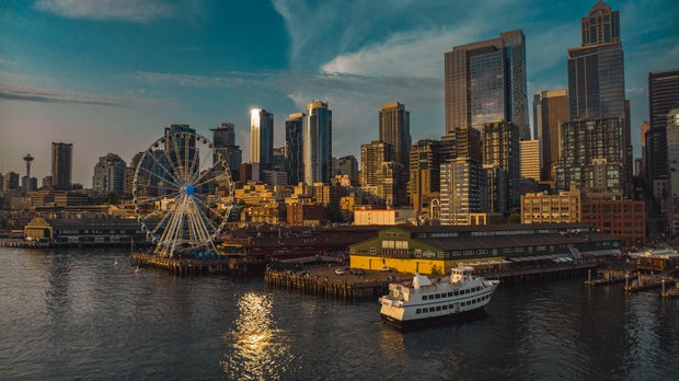 Seattle Ferry terminal shows Seattle Ferry and Seattle skyline at sunset, Washington State