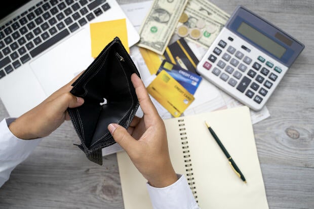 poor Asian woman hand open empty purse looking for money having problem bankrupt broke after credit card payday 