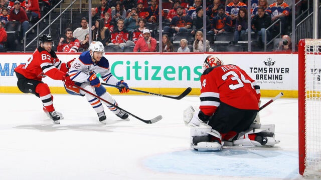 Jesper Bratt #63 and Jake Allen #34 of the New Jersey Devils defend against Vasily Podkolzin #92 of the Edmonton Oilers during the first period at Prudential Center on March 13, 2025 in Newark, New Jersey. 