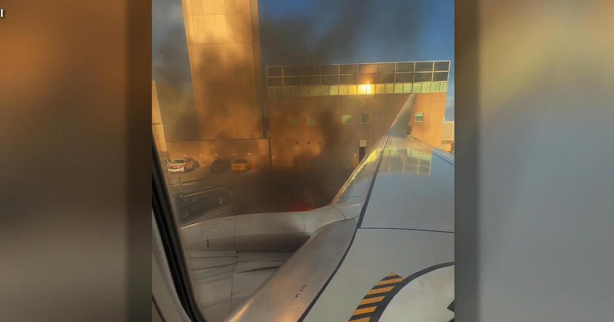 Passengers describe terrifying moments plane catches fire at Denver airport