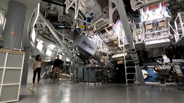 Correspondent Ben Tracy with Tammy Ma, who leads the Inertial Fusion Energy Initiative, at the National Ignition Facility in Livermore, Calif., where fusion ignition has been achieved.