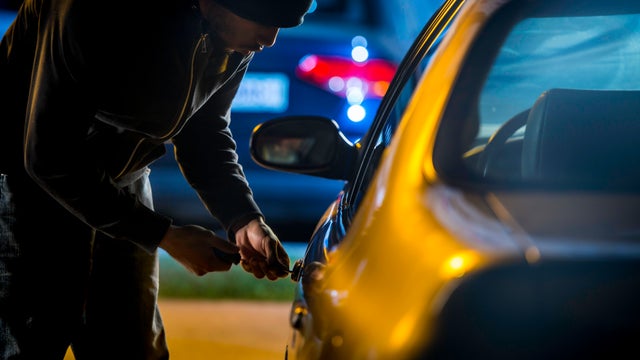Car Thief Using a Screwdriver to Brake into a Car 