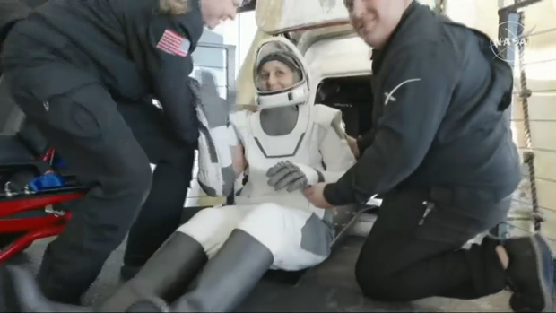 NASA astronaut Suni Williams waves as she exits the SpaceX Crew Dragon capsule
