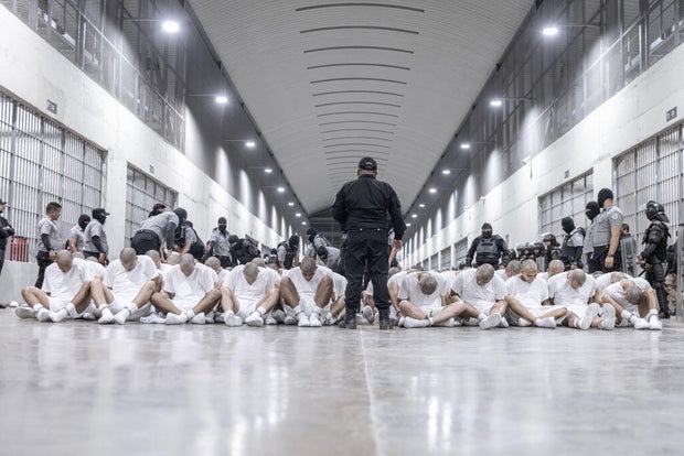 In this photo released by the Salvadoran government, inmates allegedly linked to criminal organizations and deported from the U.S. gather on the floor at CECOT in Tecoluca, El Salvador, on March 16, 2025. 