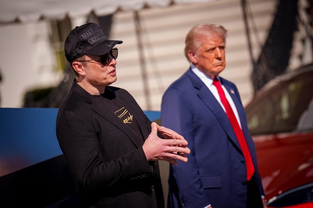 President Trump listens as White House Senior Advisor, Tesla and SpaceX CEO Elon Musk, speaks next to a Tesla Cyber Truck and a Model S on the South Lawn of the White House on March 11, 2025 in Washington, DC.