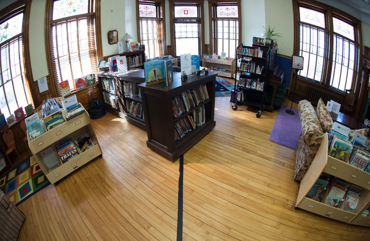 Black tape marks the U.S.-Canada border inside the Haskell Free Library 
