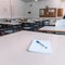 Notebook with a pen on a table in a classroom at a school 