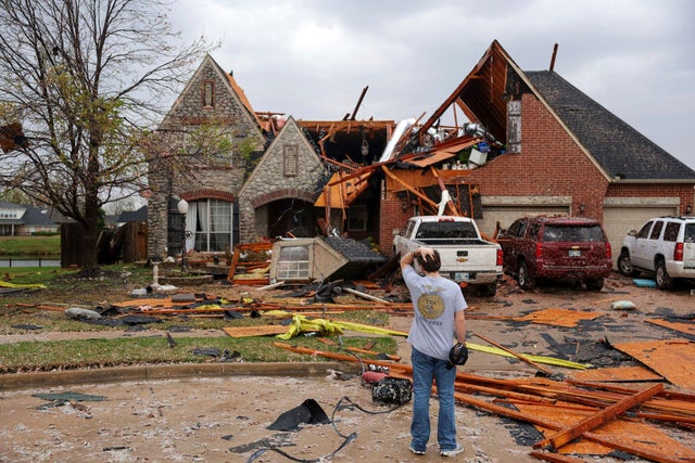 Ryland Mosley, 18, who was on the second floor of his home when a storm passed, stands outside observing the damage on April 2, 2025, in Owasso, Oklahoma. 