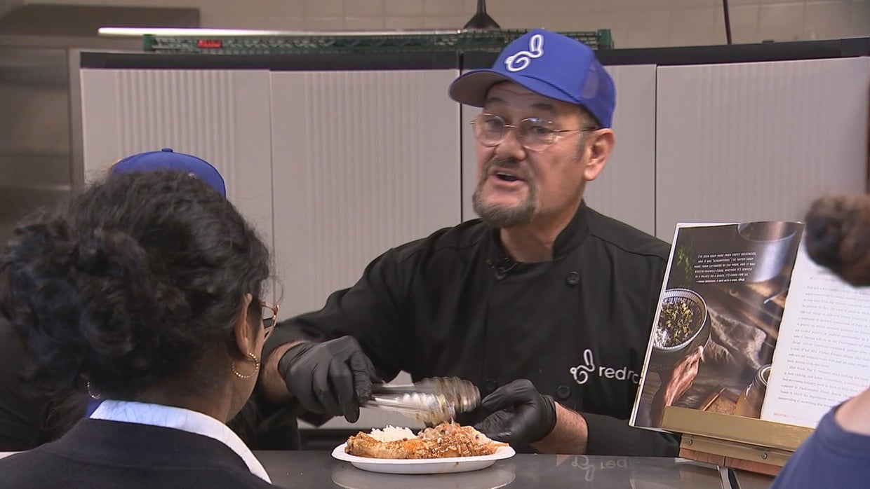 Chef Javier Ramirez serves meals to students at Tacony Academy Charter High School in Wissinoming