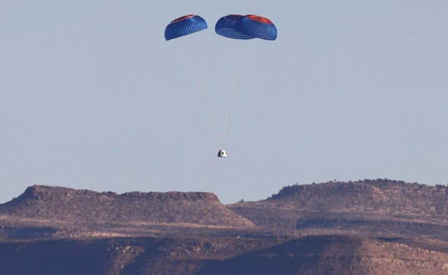 Blue Origin crew capsule descends with its parachute after a flight 