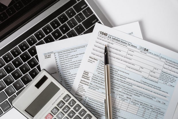 1040 Tax Form with Laptop and Calculator 